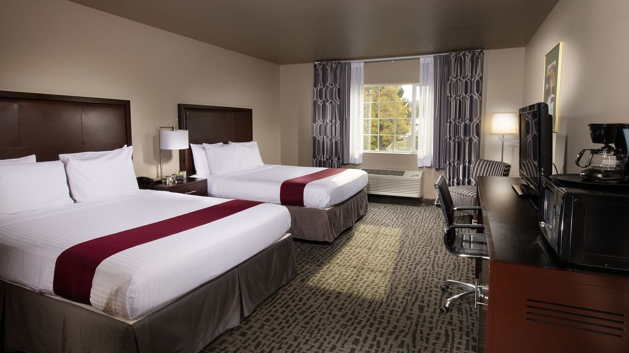 Two beds in stylish hotel room with window