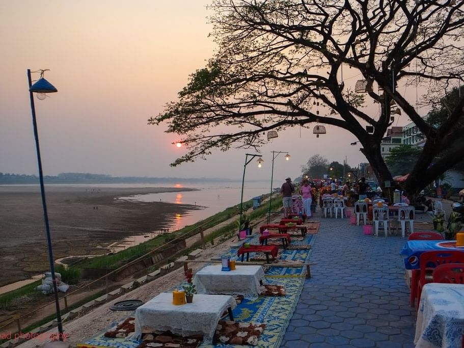 Dining tables arranged at sunset in Vientiane Riverfront near Eastin Vientiane