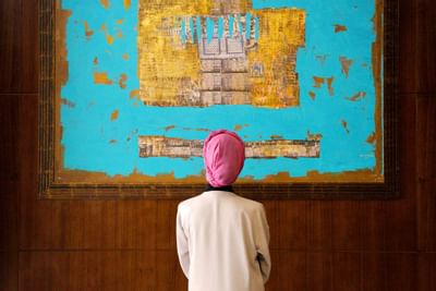 A man looking at a painting in Bay La Sun Hotel & Marina