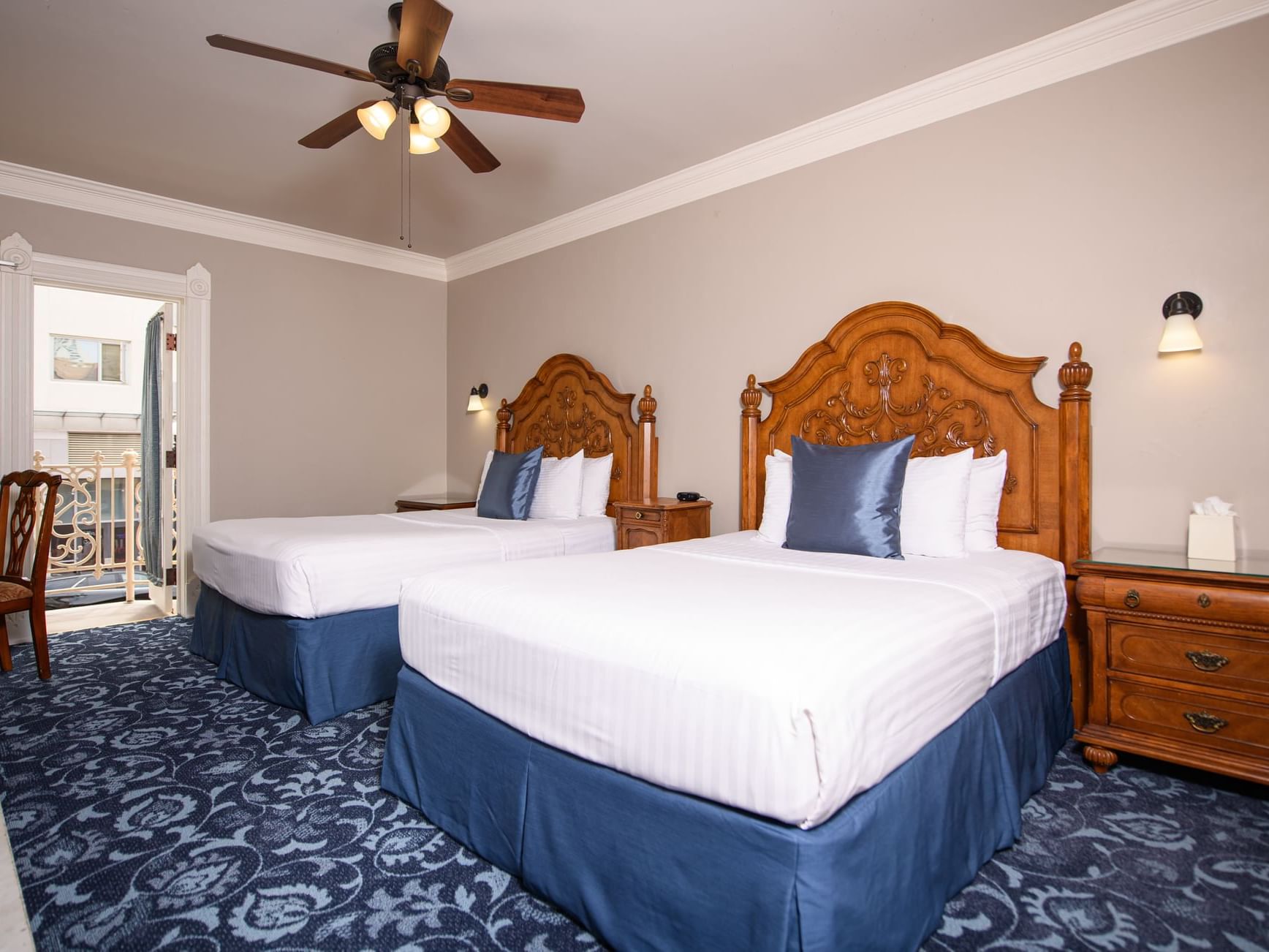 Side cupboard by the beds with carpeted floors in 2 Queen Beds Room at Horton Grand Hotel