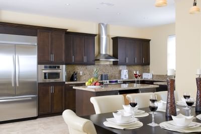 Kitchen and dining table settings in Oceanfront Penthouse Suite at Windsong Resort On The Reef