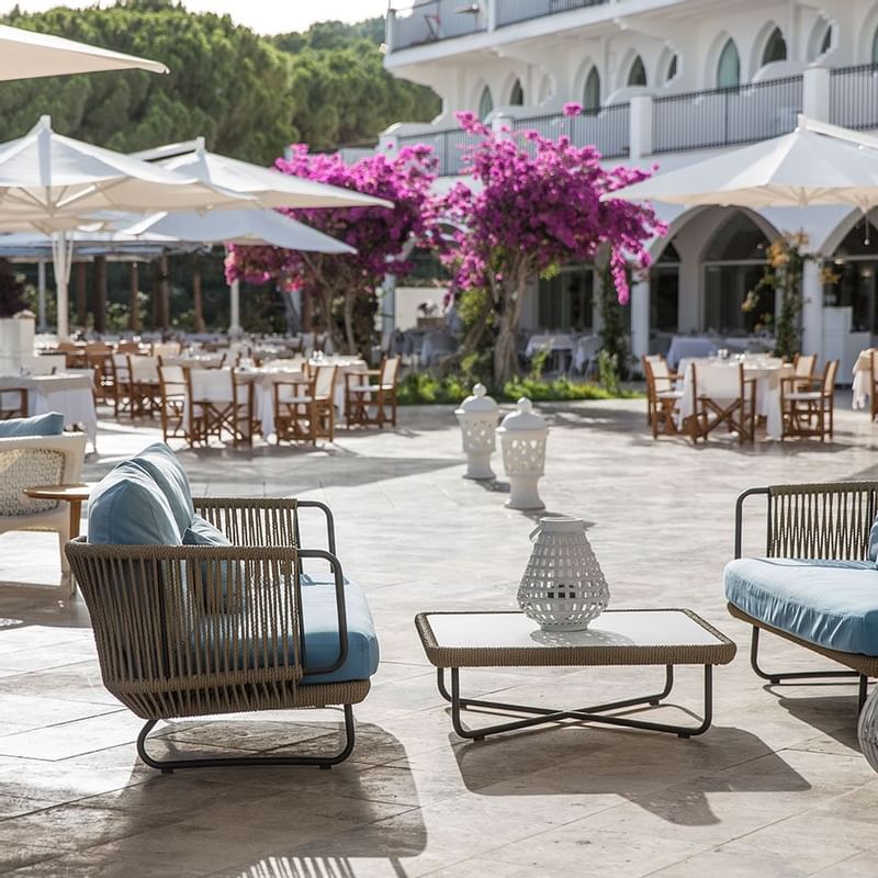 Outdoor dining area at Falkensteiner Hotel Resort Capo Boi
