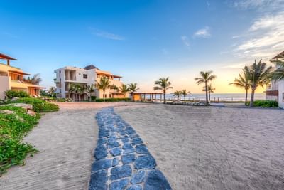 A rocky pathway by the beach near Marea Beachfront Villas