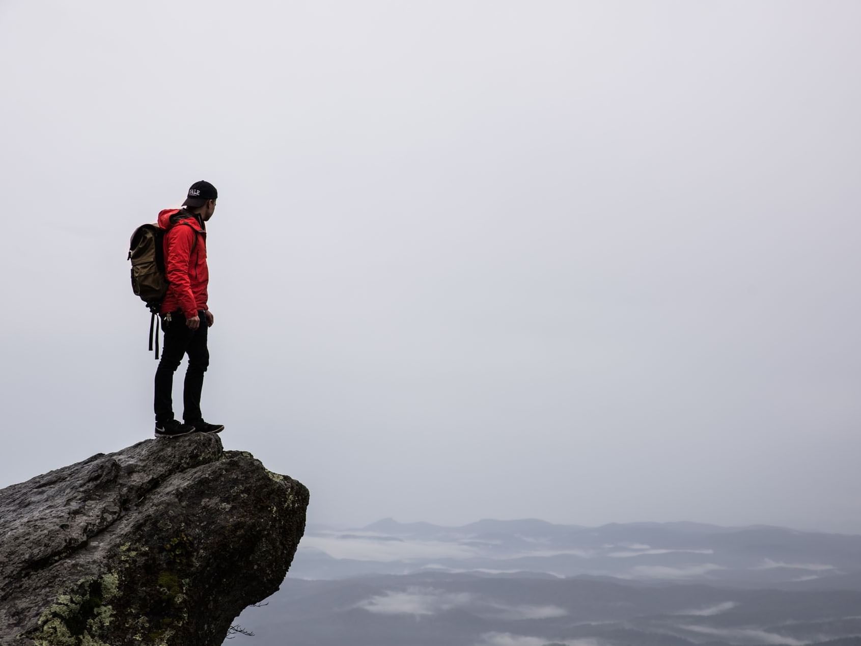 A man enjoying the view top of The Blowing Rock near The Embers Hotel