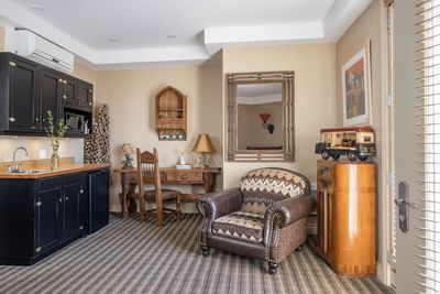 Kitchenette, work desk & comfy chair in King Superior Cowboy at Retro Suites Hotel