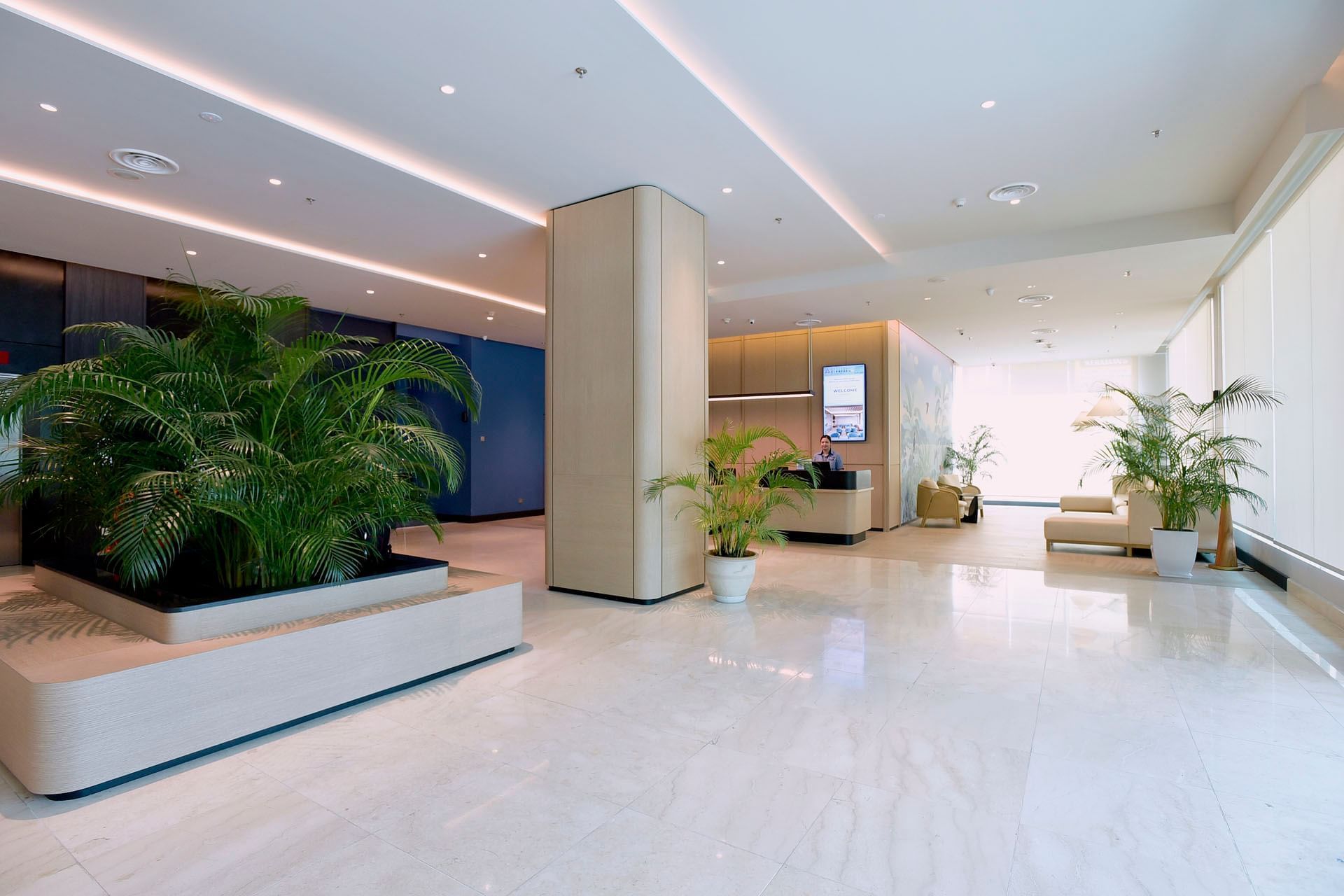 Reception desk by lobby lounge with marble floors & potted plants at Cititel Express Kota Kinabalu