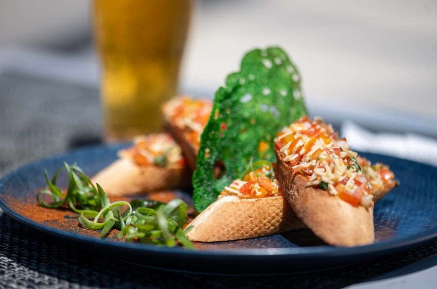 Plate of bruschetta garnished with cheese and herbs at Warwick Le Lagon - Vanuatu.