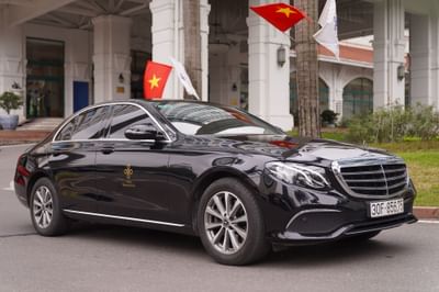 Luxurious Mercedes Benz parked in front of a Hanoi Daewoo Hotel