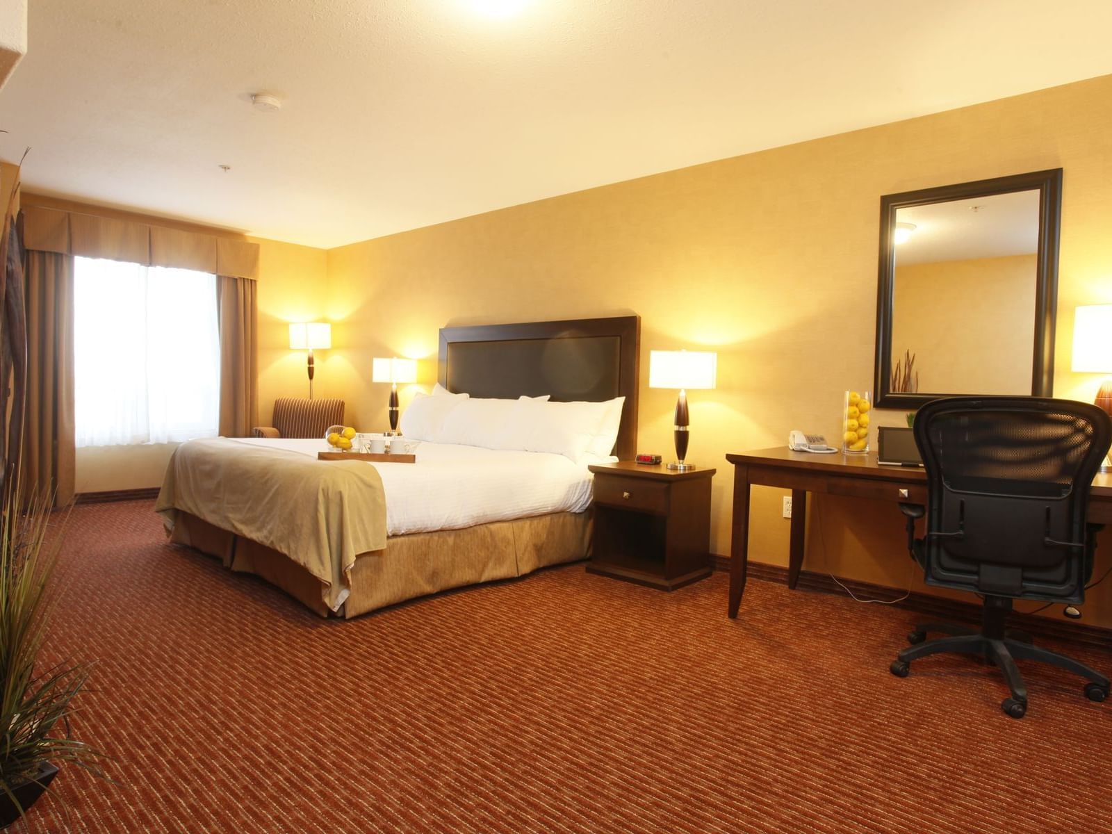 a bed and desk in a hotel room
