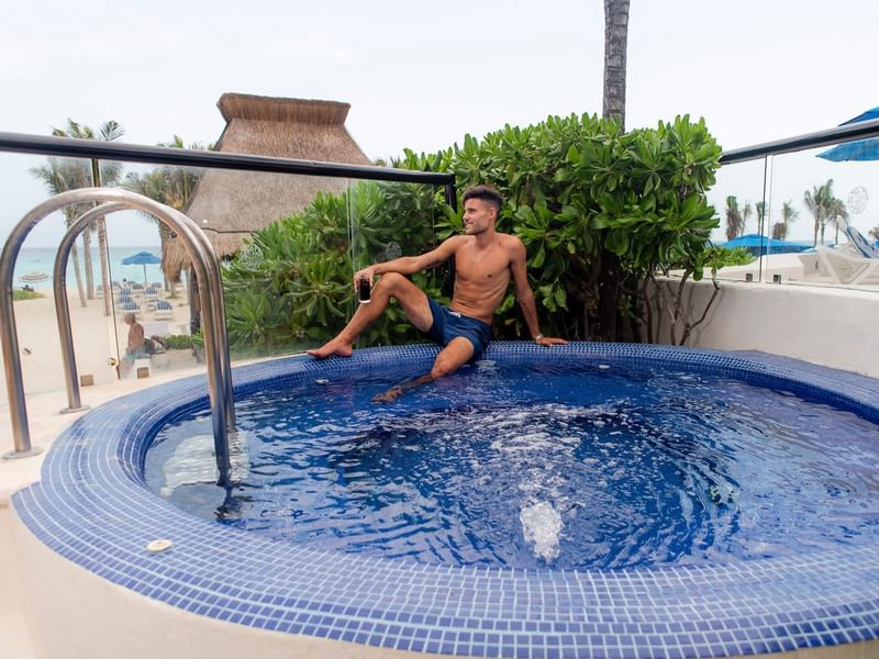 Boy sitting in jacuzzi at the Reef Playacar