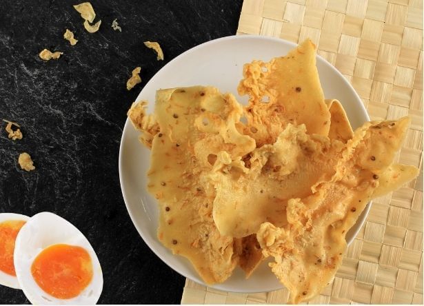 Close-up of snack dish with large crackers and pieces of hard-boiled egg served at Sunway Velocity Hotel