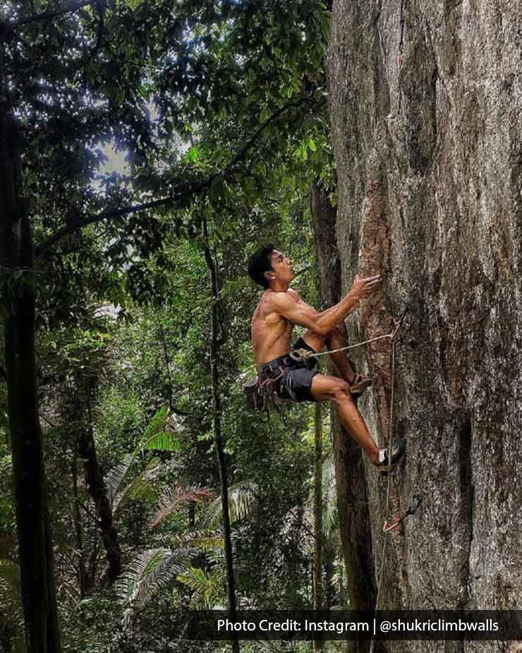 solo rock climber scaling a challenging cliff face - Lexis MY