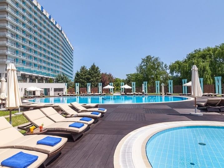 Sunbeds by the outdoor swimming pool at Ana Hotels Europa