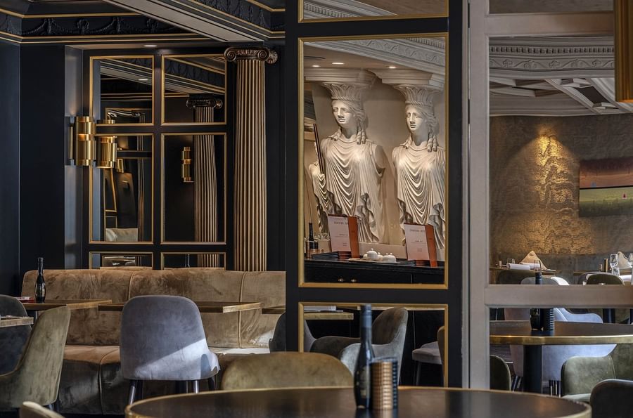 Sophisticated dining room with mirrors and upholstered chairs & sofas at Hotel Barsey by Warwick