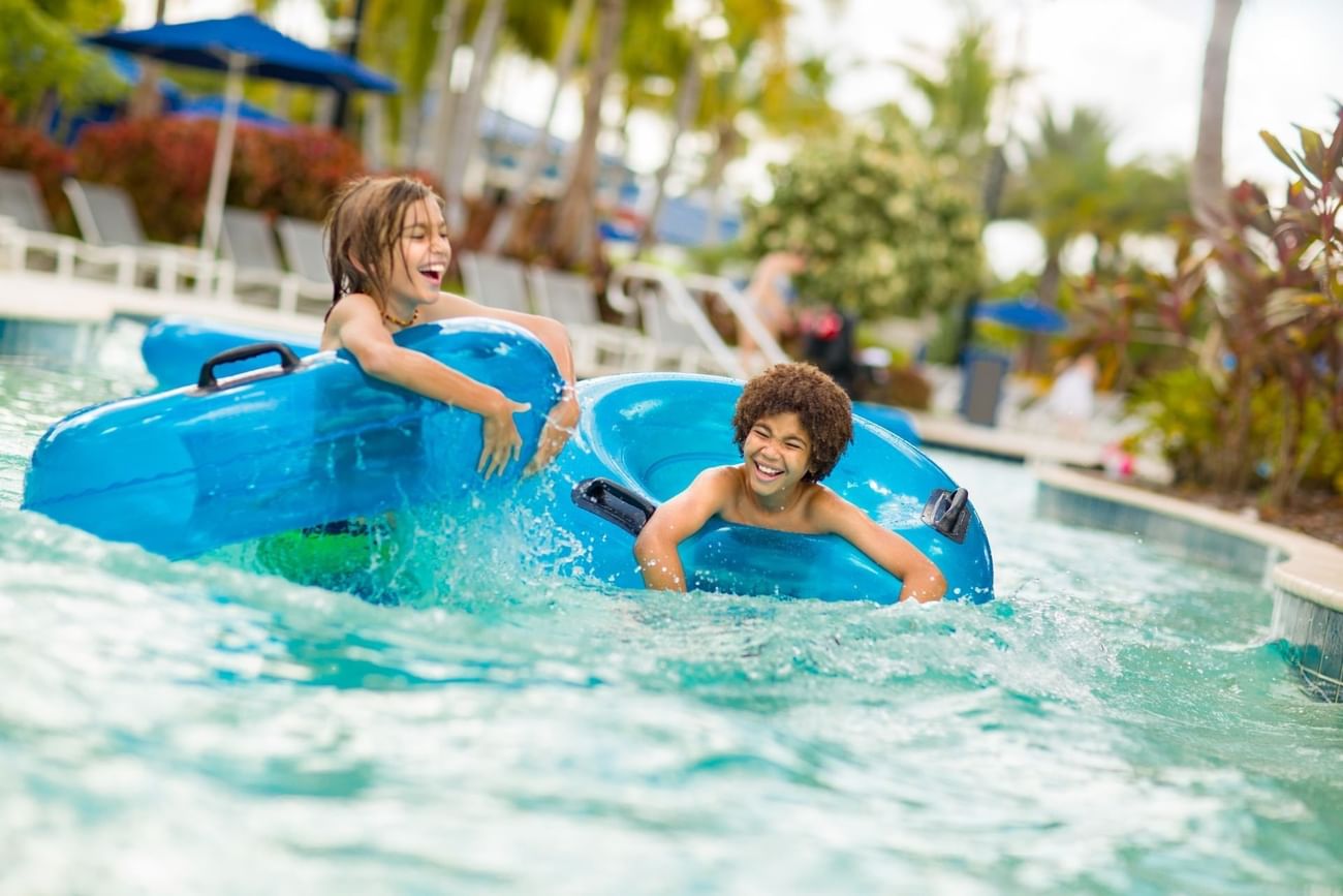 Two kids enjoying on tubes in Surfari Water Park at The Grove Resort & Water Park