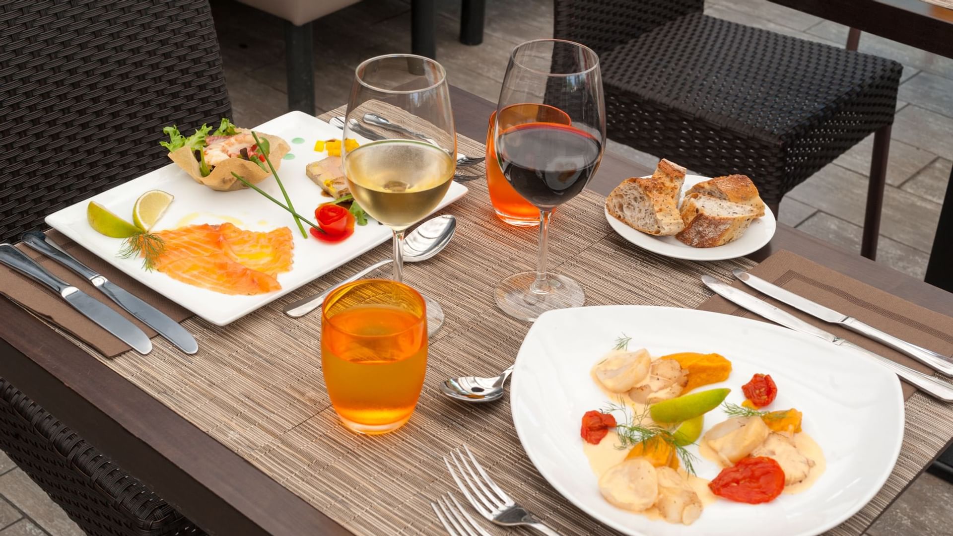 Closeup of meals served with wine at Hotel de la Plage