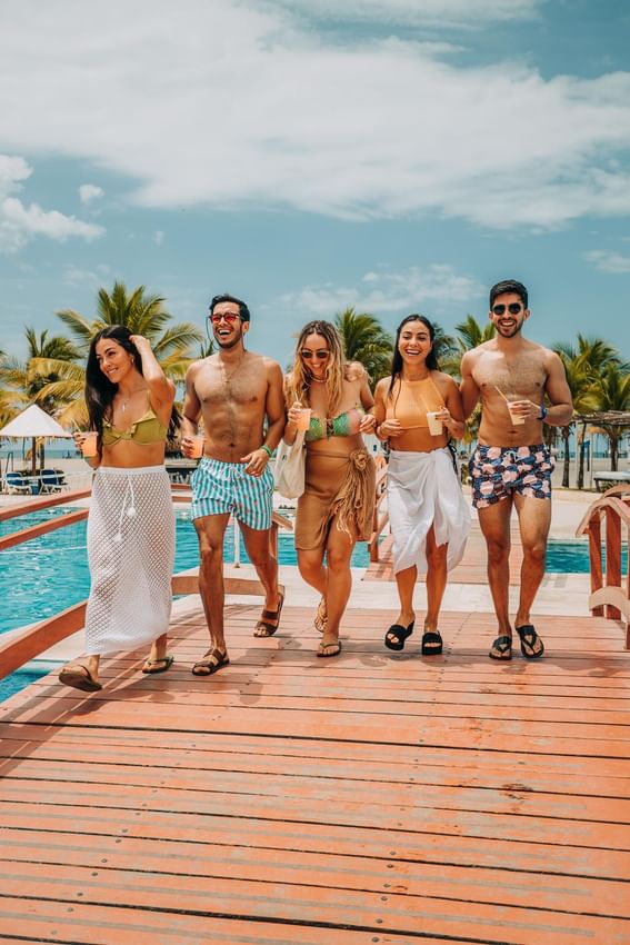 Friends enjoying by the outdoor pool at Playa Blanca Beach Resort