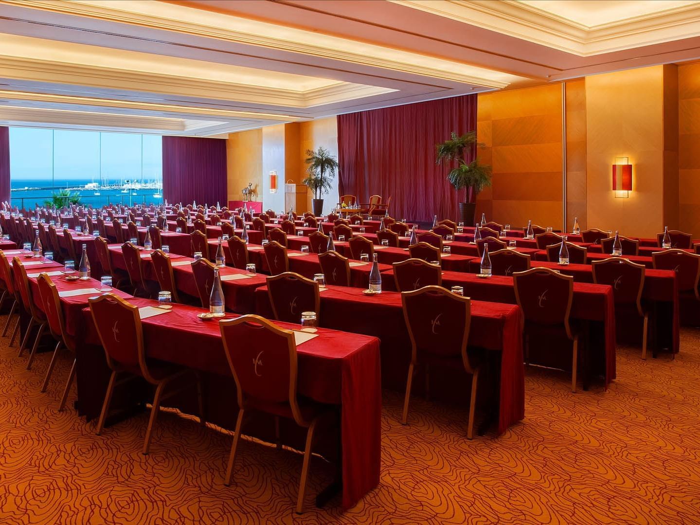 Meeting room arranged with red chairs at Hotel Cascais Miragem