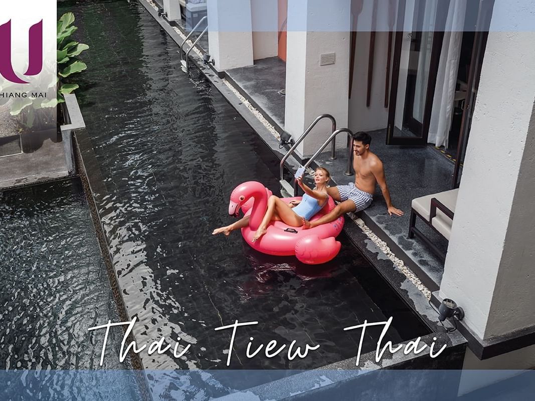 Couple on swimming pool with swim ring at U Hotels and Resorts