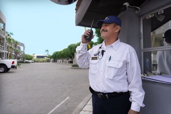 Security guard holding a walkie-talkie at Araiza Hotel Calafia