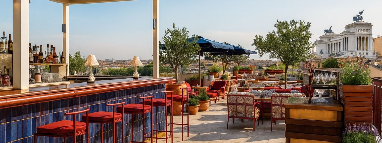 Lyve Rooftop Terrace at Thompson Rome with red stools and lounge seating, overlooking the city from a luxury hotel in Rome