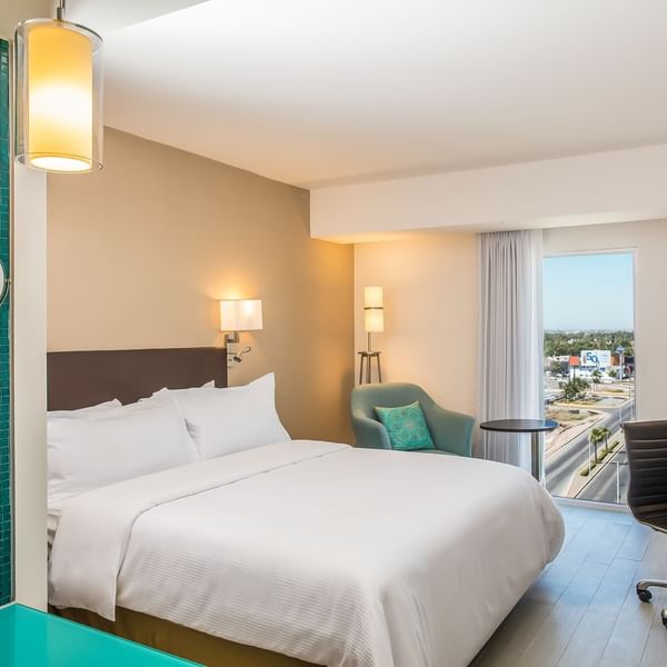 King bed with working desk in Superior Room at Fiesta Inn