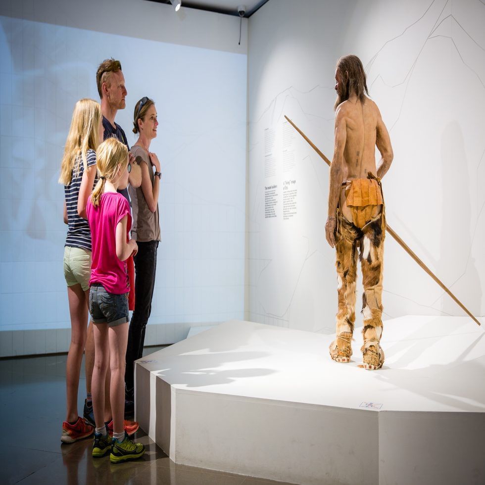 Family looking at wax models in South Tyrol Museum Of Archaeology near Falkensteiner Hotels