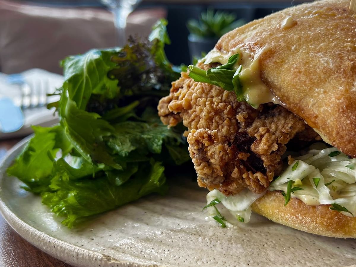 Chicken burger dressed with salad and on a fresh bun