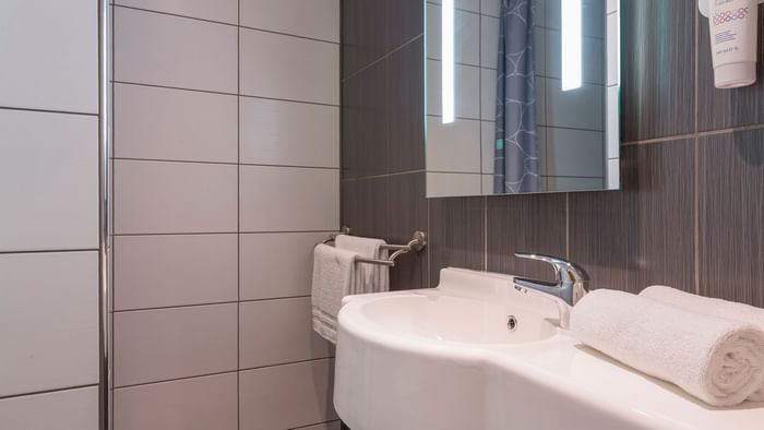 Bathroom vanity in bedrooms at Hotel Aster
