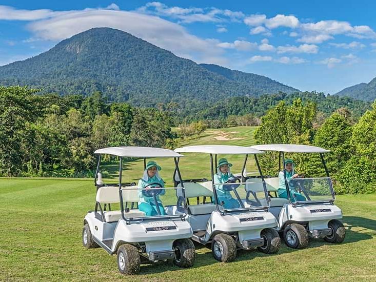 Three golf carts with attendants at Chatrium Golf Resort