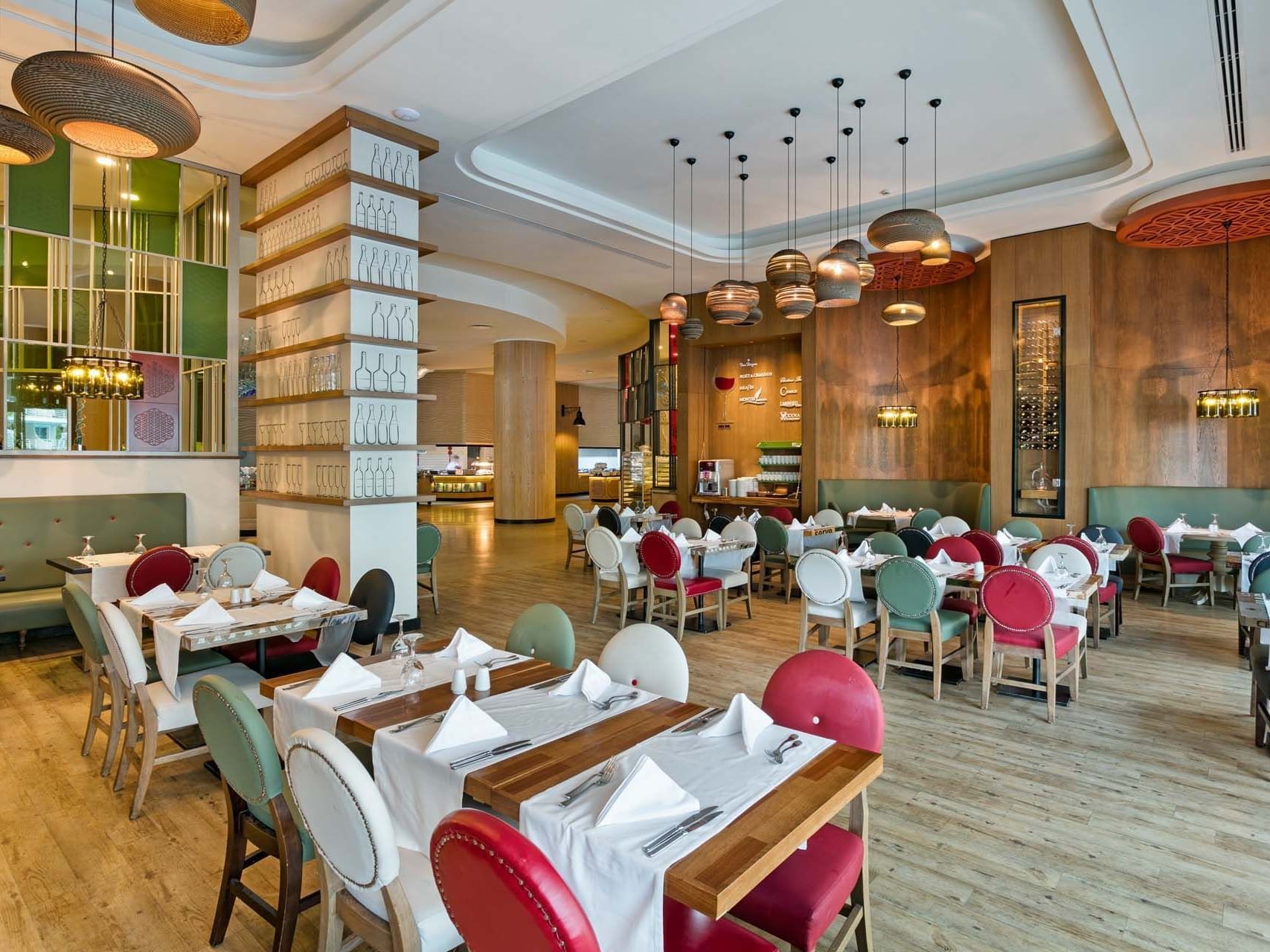 Interior of dining area with tables and chairs in Parkfora Main Restaurant at Titanic Deluxe Lara