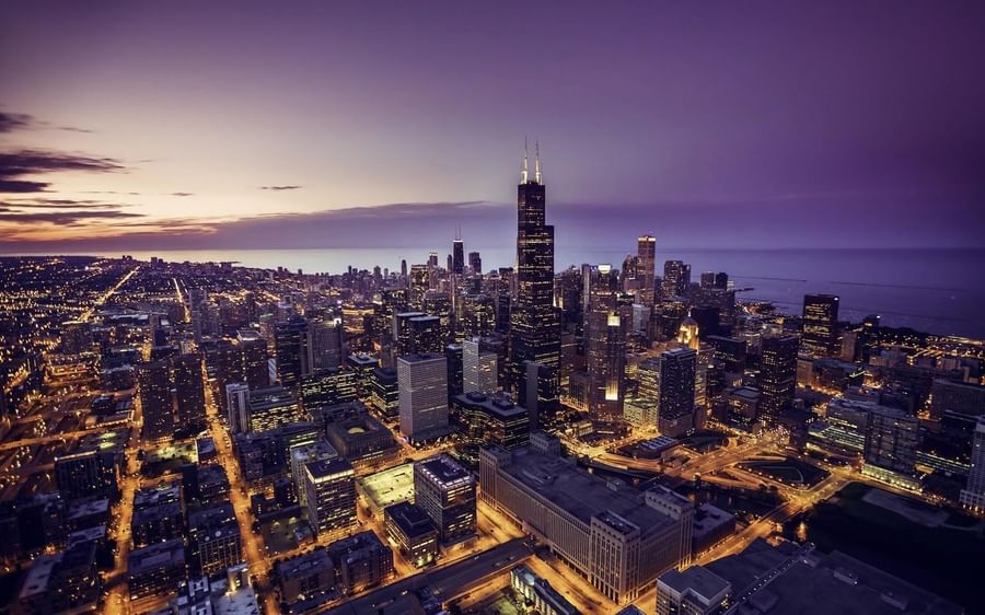 Glowing Chicago skyline at dusk, viewed from high above the streets near Warwick Allerton Chicago