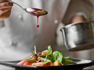 Close-up of a chef garnishing a dish at Starling Hotel, best restaurants in Lausanne