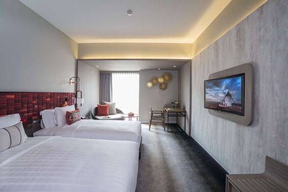 Room with two double beds and smart tv at U Hotels & Resorts