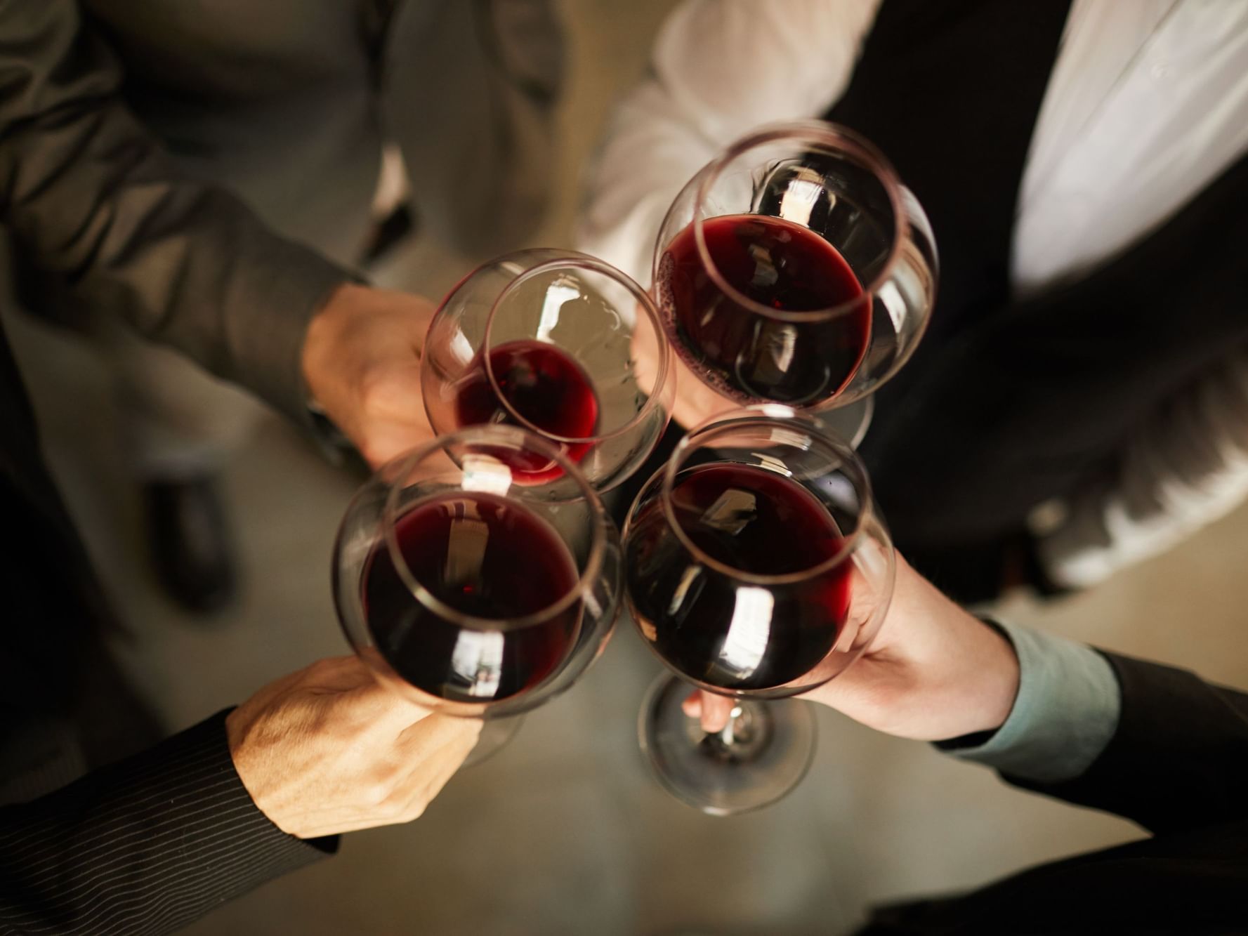 Close-up of friends toasting wine glasses at Park Hotel Hong Kong