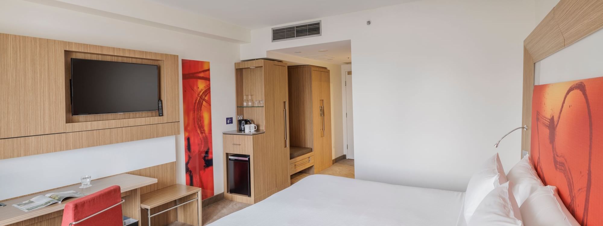 TV, work desk, and Coffee Station by the comfy bed in Superior Accessible Room at Novotel Sydney Olympic Park