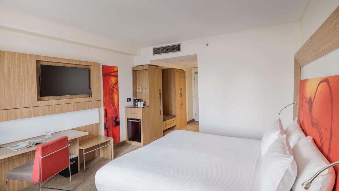 TV, work desk, and Coffee Station by the comfy bed in Superior Accessible Room at Novotel Sydney Olympic Park