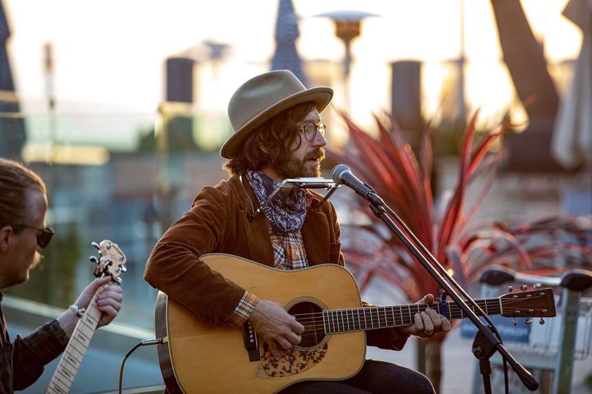 Chis Beland playing guitar outside 