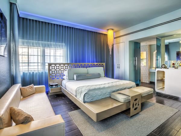 Gold Junior Suite with king bed & a sofa at Dream South Beach