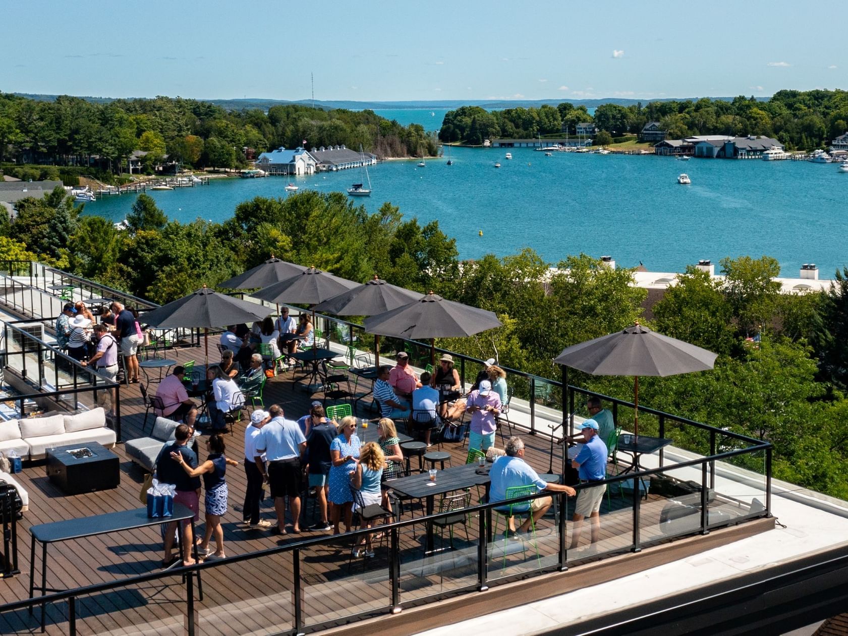 People hanging out on the rooftop lounge area with a sea view in HI Bar at The Earl