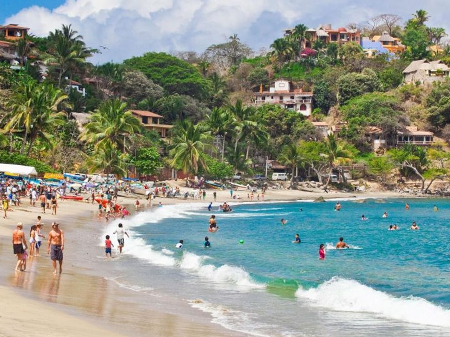 People enjoying the Playa Sayulita beach near Plaza Pelicanos Club Beach Resort