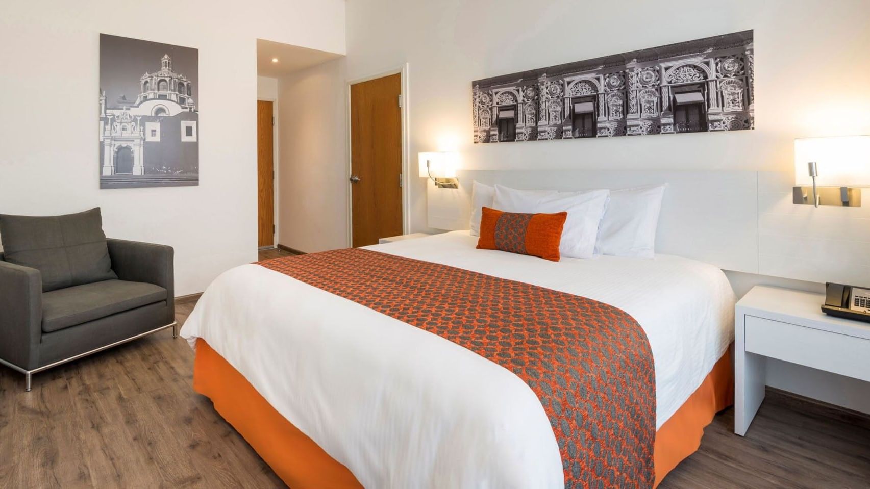 King Suite 1 Room room at Camino Real Puebla Angelopolis, featuring a plush bed and stylish wooden door entry area