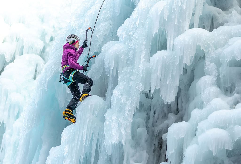 women ice climbing an ice wall