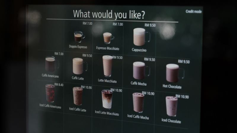 Menu board displaying various coffee drinks with prices at Sunway Velocity Hotel
