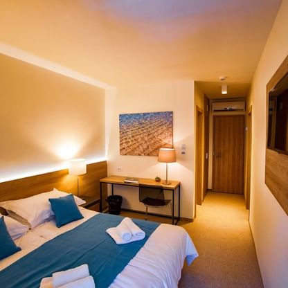 Bed & furniture in Double Room Economy at Senses Resor