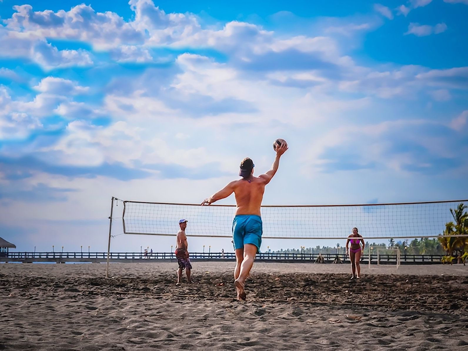 Group of three playing beach Volleyball at Fiesta Resort