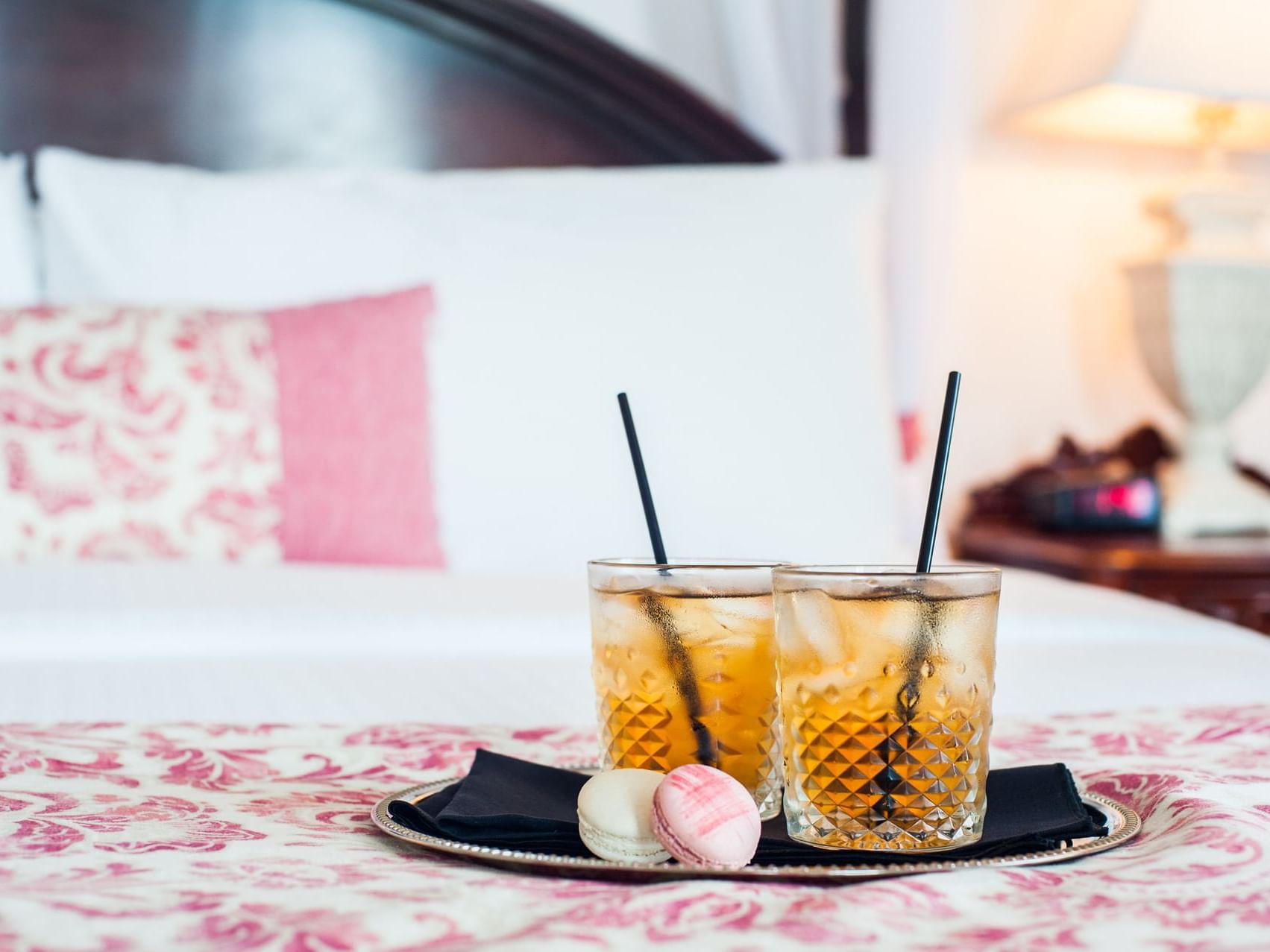 Two glasses of Iced tea and a macaroon served in a bedroom at Pendray Inn & Tea House