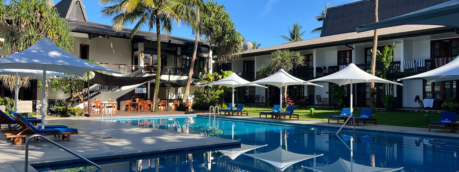 Sunny day view of the adult-only pool and bar at Warwick Fiji Resort and Spa in Korolevu