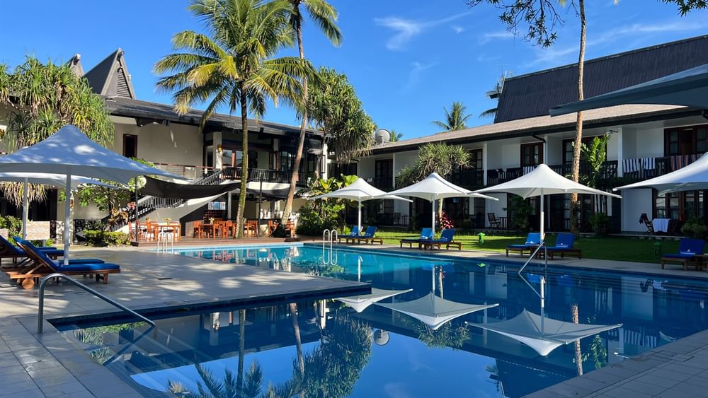 Sunny day view of the adult-only pool and bar at Warwick Fiji Resort and Spa in Korolevu.