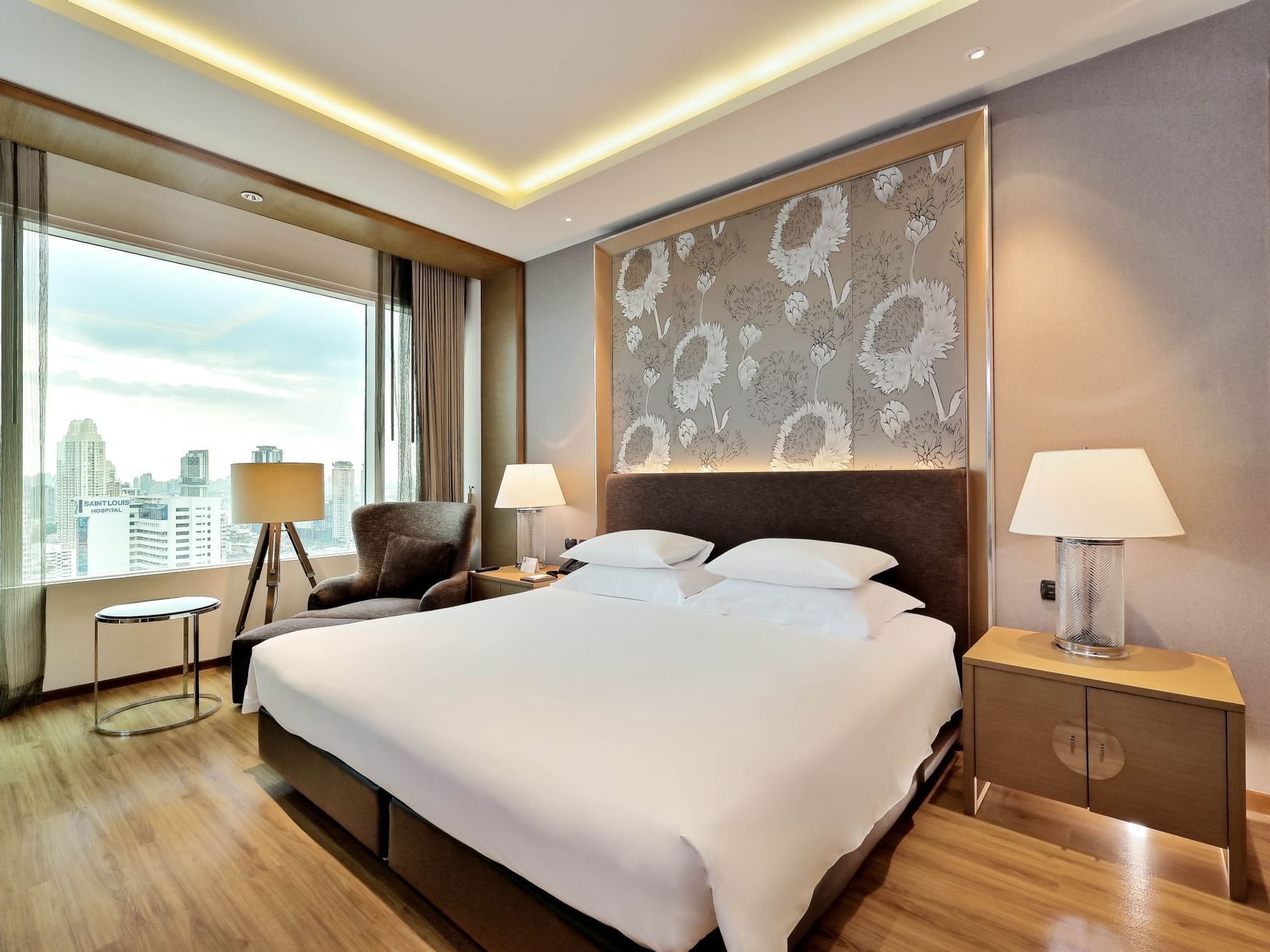 Cozy bed with city view in Junior suite at Eastin Grand Hotel Sathorn